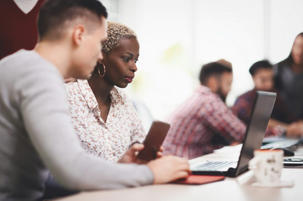 Programmers cooperating at information technology company
